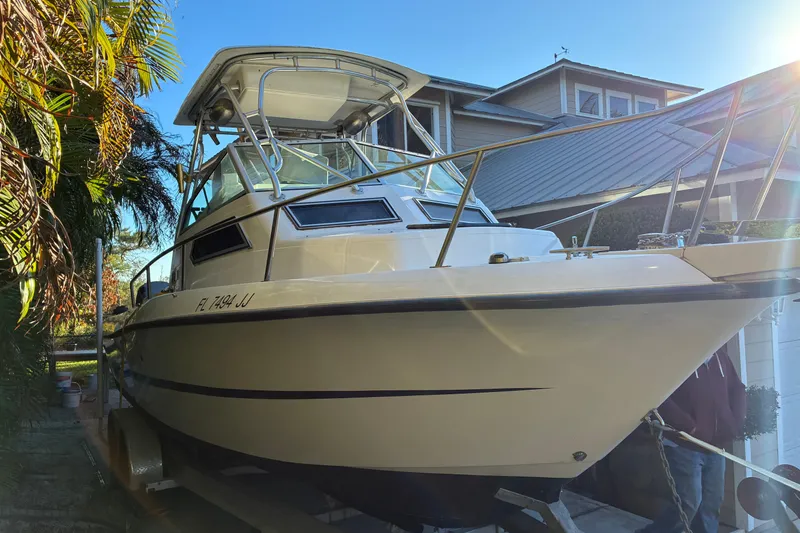 Slide: The Image of 1997 Hydra-Sports 2750 WA boat on trailer, parked near a house. - 3