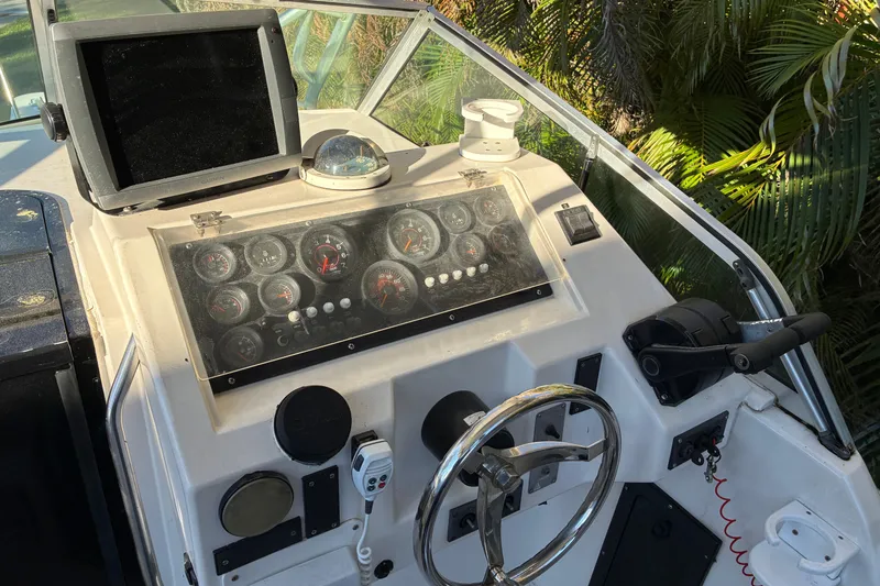 Slide: The Image of 1997 Hydra-Sports 2750 WA boat dashboard with gauges, steering wheel, and navigation equipment. - 5