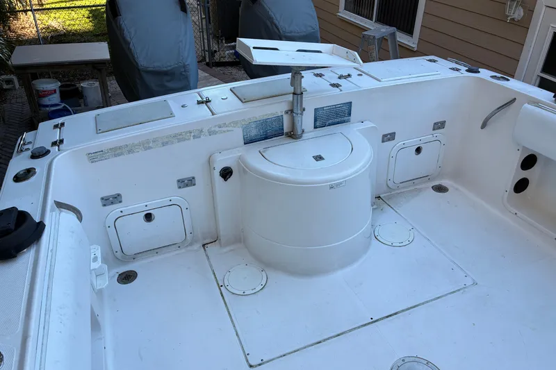 Slide: The Image of 1997 Hydra-Sports 2750 WA boat deck with storage compartments and seating area. - 6