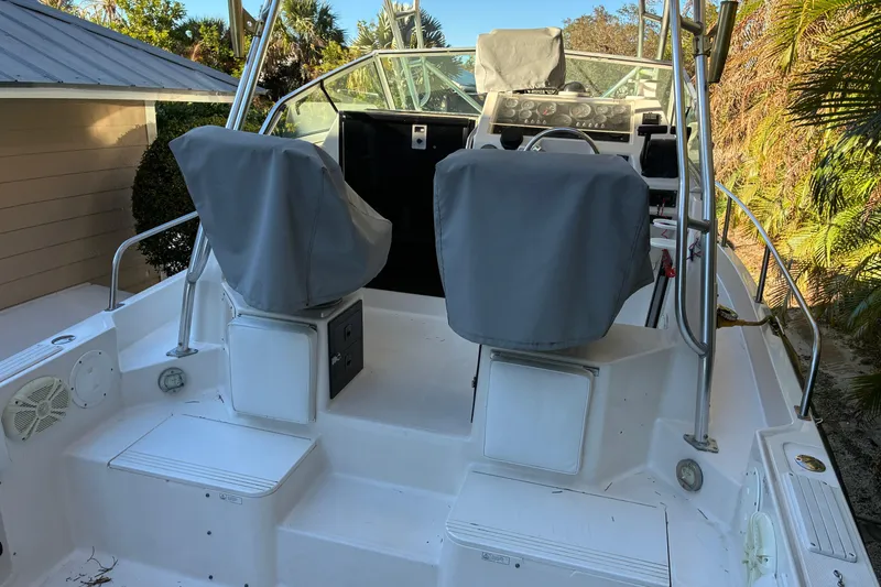 Slide: The Image of 1997 Hydra-Sports 2750 WA boat cockpit with covered seats and steering wheel. - 7