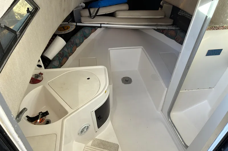 Slide: The Image of 1997 Hydra-Sports 2750 WA cabin interior with seating and storage. - 8