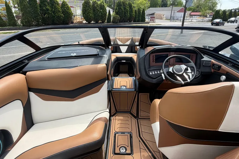 Slide: The Image of Interior of a 2020 Centurion Ri237 boat with luxurious brown and white seating. - 11