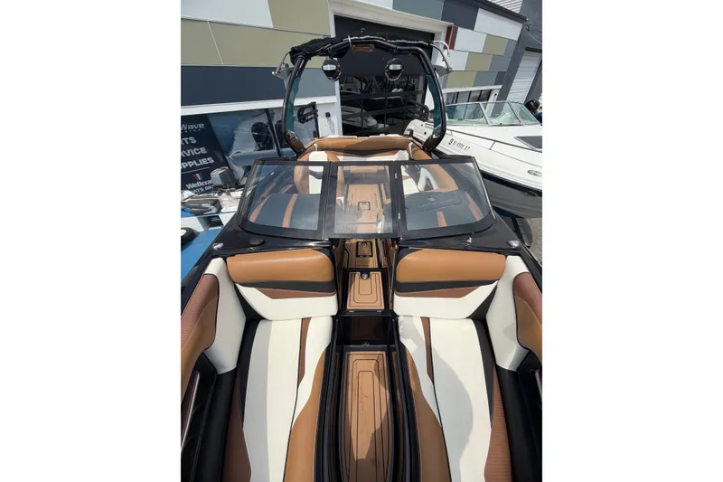 Slide: The Image of 2020 Centurion Ri237 boat interior with luxurious brown and white seating. - 17