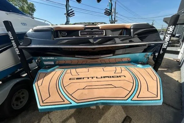 Slide: The Image of 2020 Centurion Ri237 boat on trailer, parked outdoors, featuring sleek design and vibrant colors. - 2