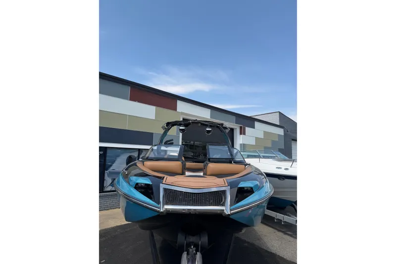 Slide: The Image of 2020 Centurion Ri237 boat with sleek design, parked outdoors under clear sky. - 6