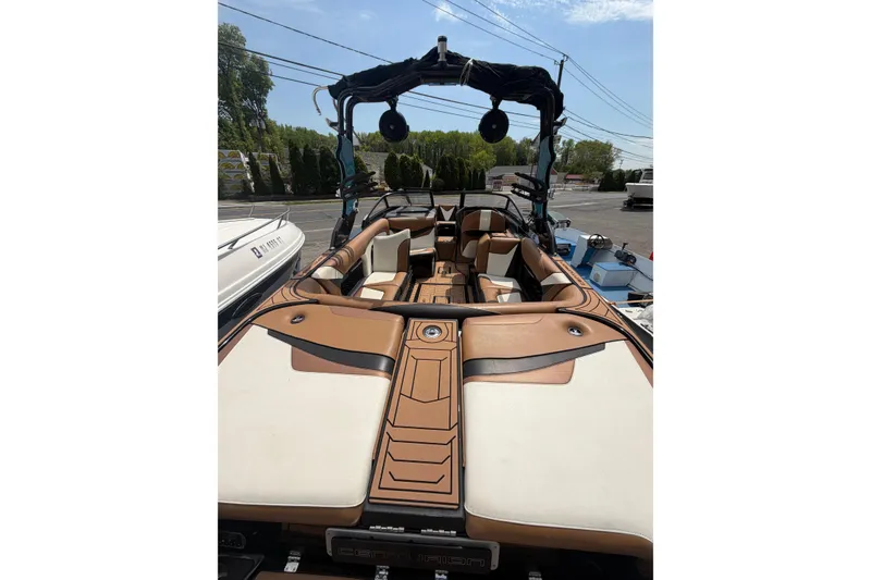 Slide: The Image of 2020 Centurion Ri237 boat with tan and white interior, docked outdoors. - 7