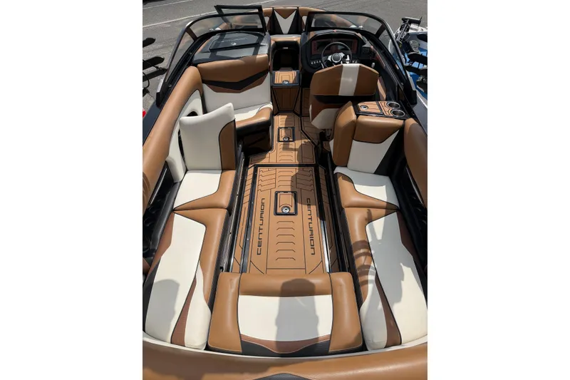 Slide: The Image of 2020 Centurion Ri237 boat interior with brown and white seating, sleek design. - 8
