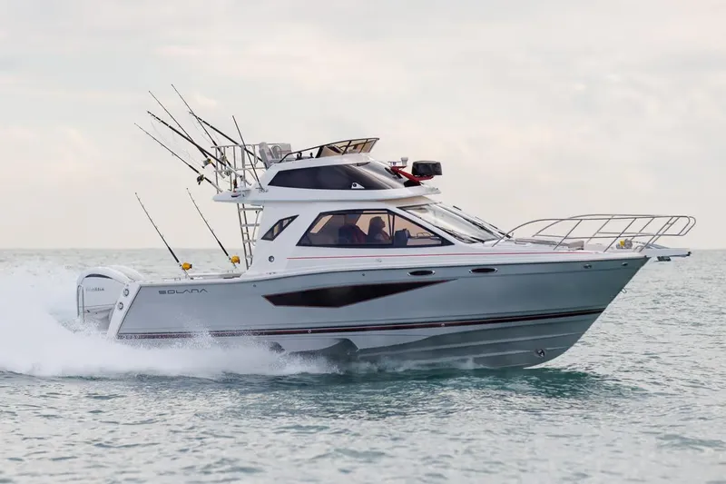 The Image of Manufacturer Provided Image: 2026 Solara S-310 SB boat cruising on open water, equipped with fishing rods. - 0