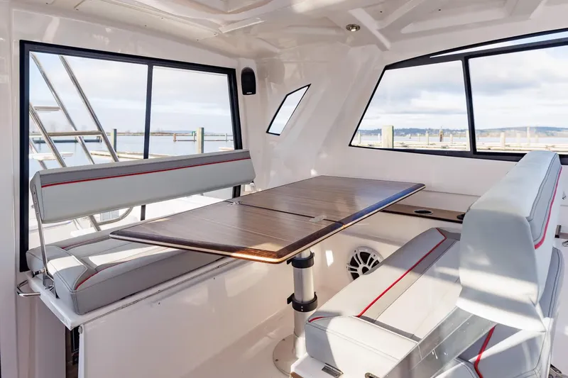 Slide: The Image of Manufacturer Provided Image: Interior of 2026 Solara S-310 SB boat with seating and table. - 3