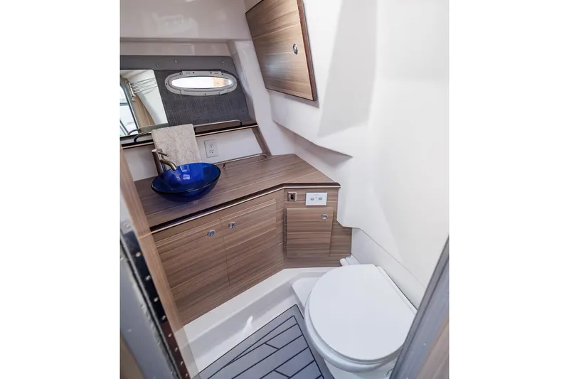 Slide: The Image of Manufacturer Provided Image: Modern bathroom in 2026 Solara S-310 SB boat with sleek wood cabinetry and blue vessel sink. - 7
