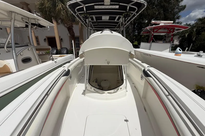 Slide: The Image of 2001 Wellcraft 29 Scarab Sport Open boat interior with open hatch, showcasing sleek design. - 101