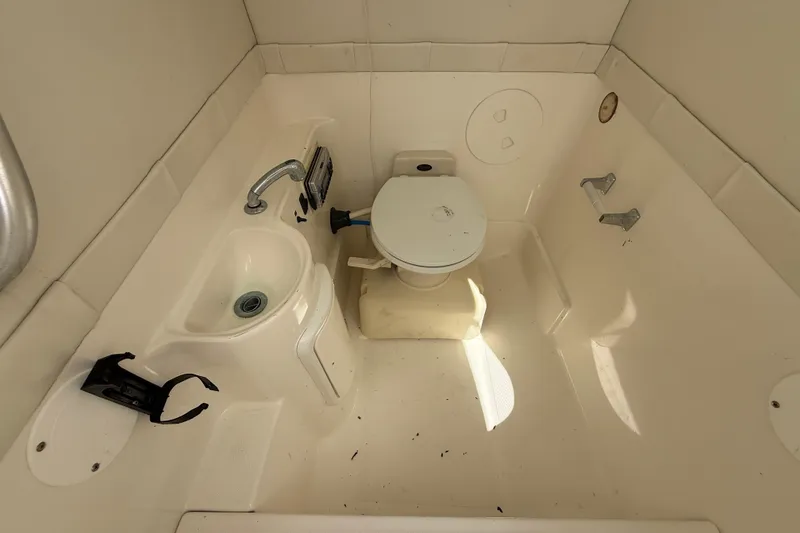 Slide: The Image of 2001 Wellcraft 29 Scarab Sport Open boat bathroom with sink and toilet. - 103