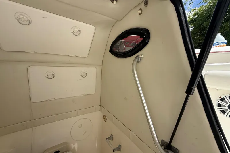 Slide: The Image of Interior view of 2001 Wellcraft 29 Scarab Sport Open boat, featuring storage compartments and porthole. - 105
