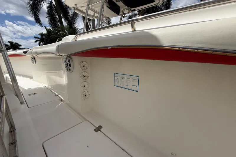 Slide: The Image of 2001 Wellcraft 29 Scarab Sport Open boat interior with speakers and palm trees in background. - 106