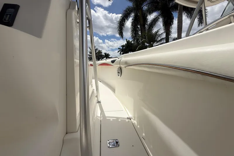 Slide: The Image of 2001 Wellcraft 29 Scarab Sport Open boat deck with palm trees and cloudy sky. - 108