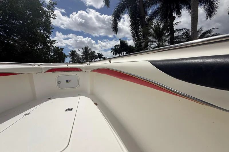 Slide: The Image of 2001 Wellcraft 29 Scarab Sport Open boat interior with palm trees and cloudy sky. - 110