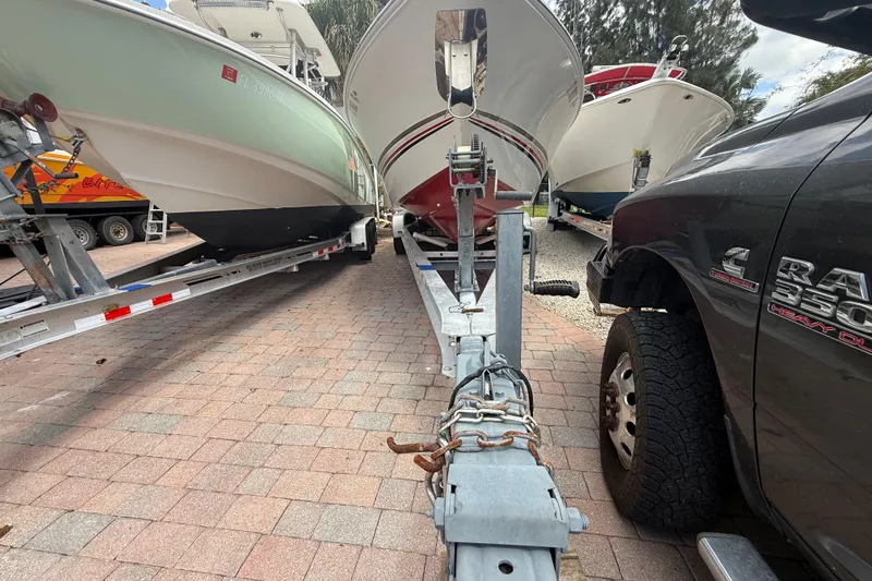 Slide: The Image of 2001 Wellcraft 29 Scarab Sport Open on trailer, parked beside a truck. - 13