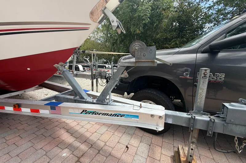 Slide: The Image of 2001 Wellcraft 29 Scarab Sport Open on trailer, parked beside a truck. - 15