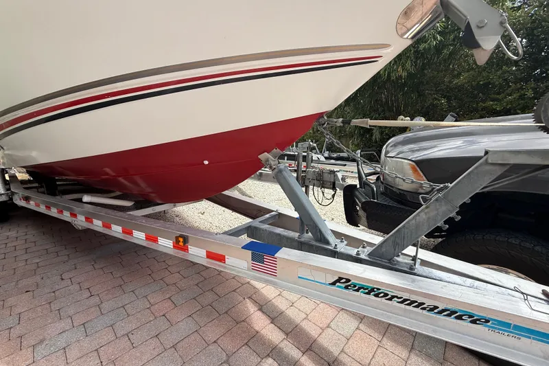 Slide: The Image of 2001 Wellcraft 29 Scarab Sport Open boat on a Performance trailer. - 16