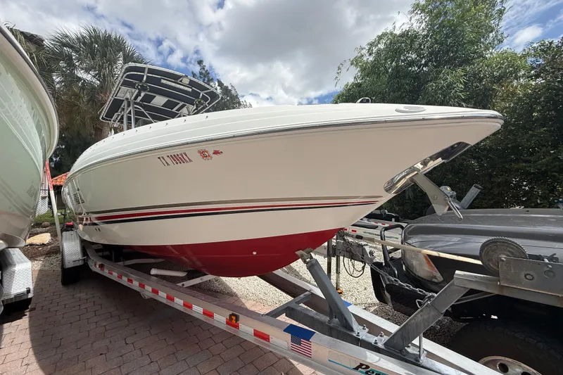 Slide: The Image of 2001 Wellcraft 29 Scarab Sport Open boat on trailer, parked outdoors. - 17