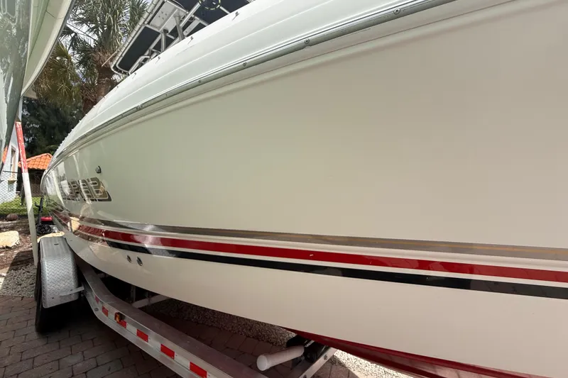 Slide: The Image of 2001 Wellcraft 29 Scarab Sport Open boat on trailer, side view. - 19