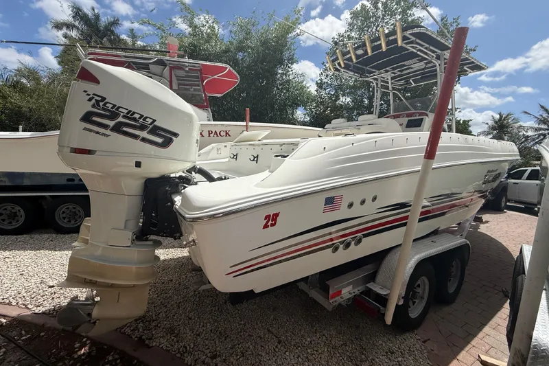 The Image of 2001 Wellcraft 29 Scarab Sport Open boat with Mercury Racing 225 engine on trailer. - 2