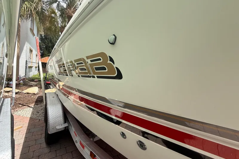 Slide: The Image of 2001 Wellcraft 29 Scarab Sport Open boat on trailer, side view with logo. - 20