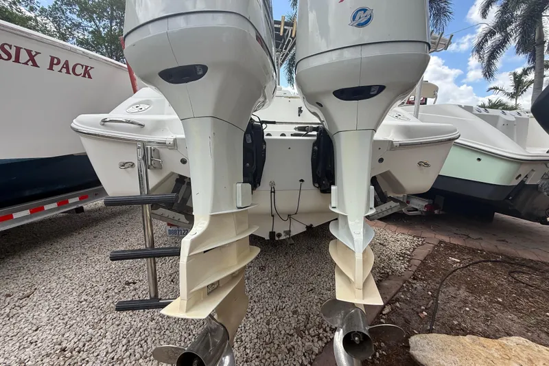 Slide: The Image of Rear view of a 2001 Wellcraft 29 Scarab Sport Open with dual outboard motors. - 27