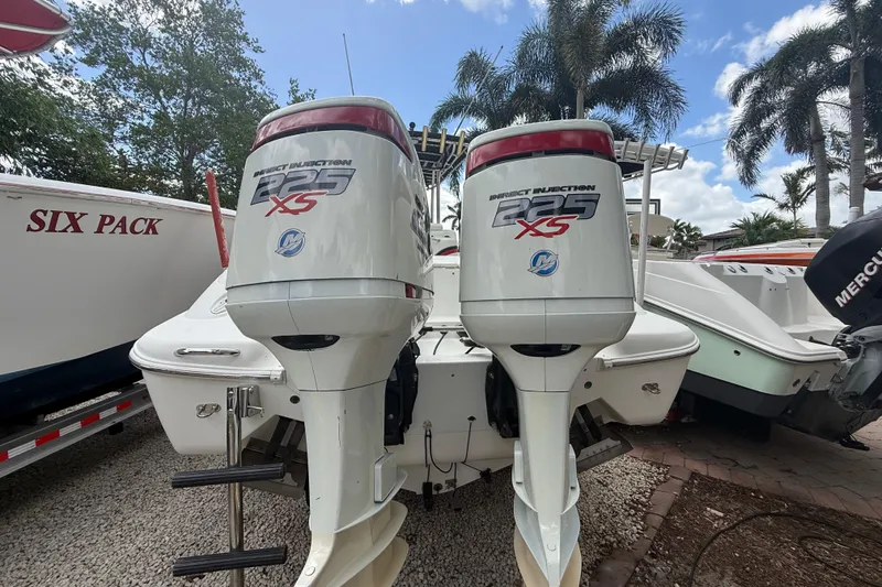 Slide: The Image of 2001 Wellcraft 29 Scarab Sport Open with twin 225 XS outboard engines, parked outdoors. - 29