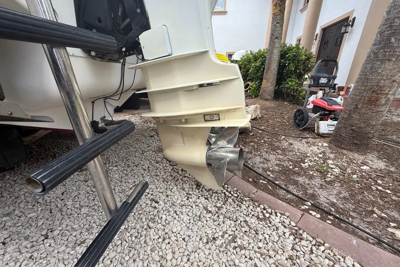 Slide: The Image of 2001 Wellcraft 29 Scarab Sport Open boat propeller and ladder on gravel surface. - 30