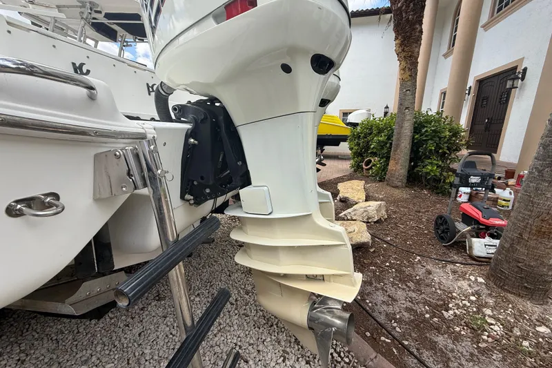 Slide: The Image of 2001 Wellcraft 29 Scarab Sport Open boat with outboard motor, parked near a house. - 31