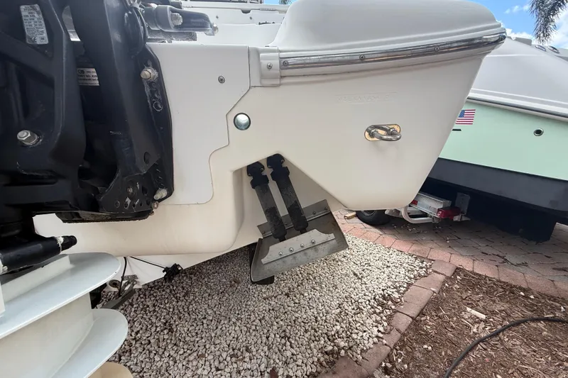 Slide: The Image of 2001 Wellcraft 29 Scarab Sport Open boat stern detail with trim tabs and outboard motor. - 39