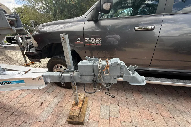 Slide: The Image of Trailer hitch attached to a Ram 3500 truck, parked on a brick driveway. - 42
