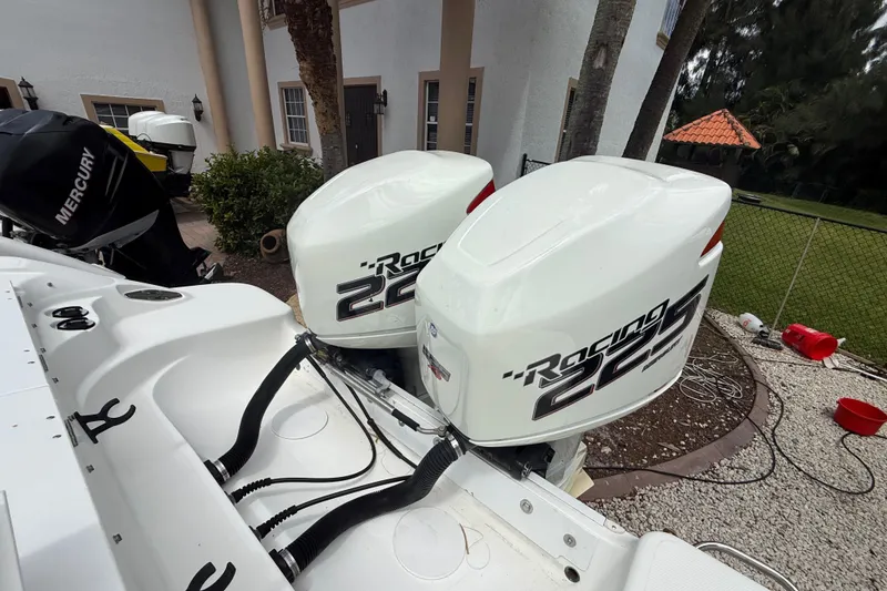 Slide: The Image of Twin Racing 225 outboard engines on a 2001 Wellcraft 29 Scarab Sport Open boat. - 43