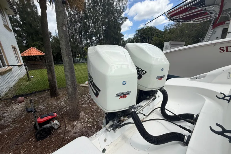 Slide: The Image of Twin outboard engines on a 2001 Wellcraft 29 Scarab Sport Open boat. - 45