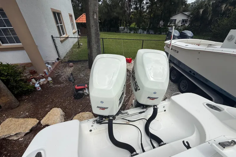 Slide: The Image of 2001 Wellcraft 29 Scarab Sport Open with twin outboard engines in a residential setting. - 46