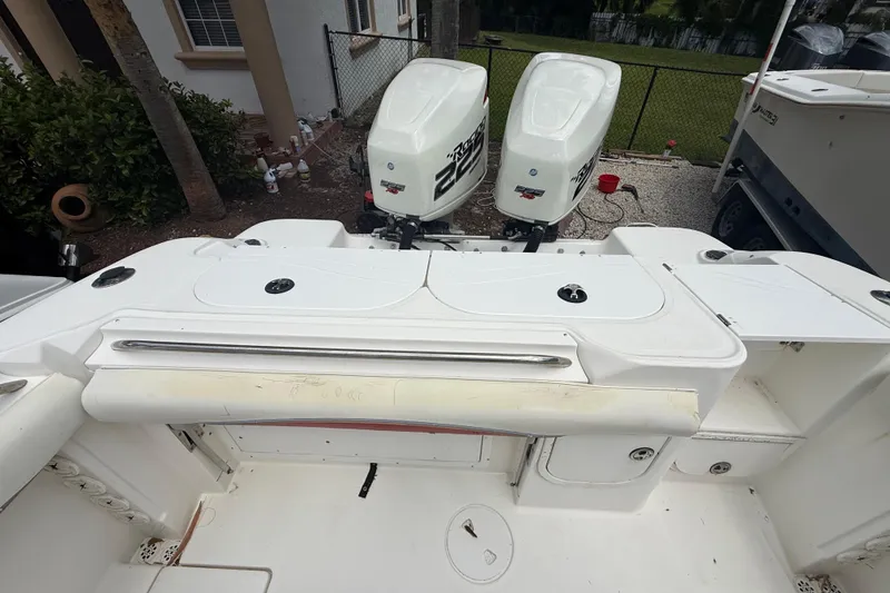 Slide: The Image of 2001 Wellcraft 29 Scarab Sport Open boat with twin outboard engines, docked in a residential area. - 48