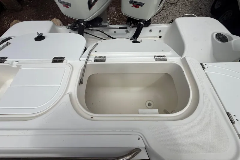 Slide: The Image of 2001 Wellcraft 29 Scarab Sport Open boat with open storage compartments and dual outboard engines. - 50
