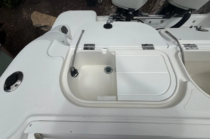 Slide: The Image of 2001 Wellcraft 29 Scarab Sport Open boat deck with storage compartment and fittings. - 51