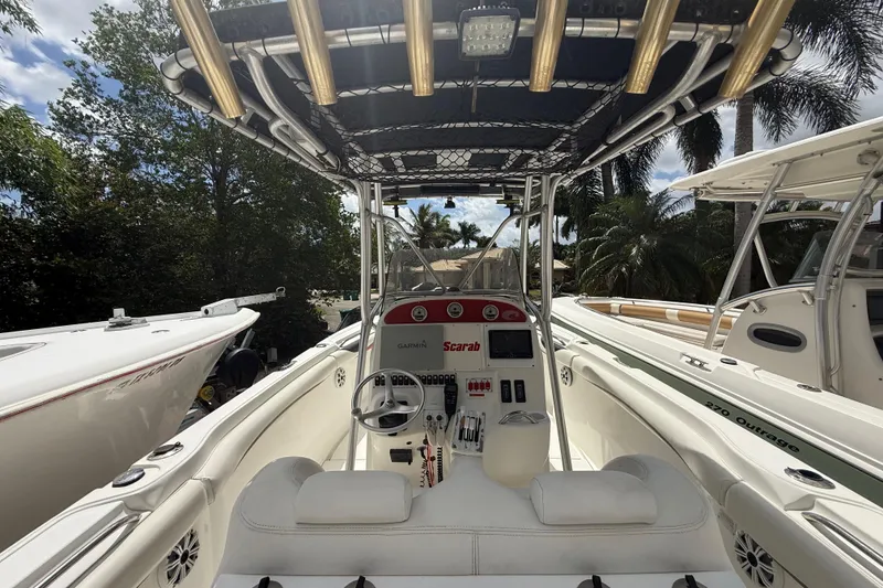 Slide: The Image of 2001 Wellcraft 29 Scarab Sport Open boat interior with steering console and seating. - 59