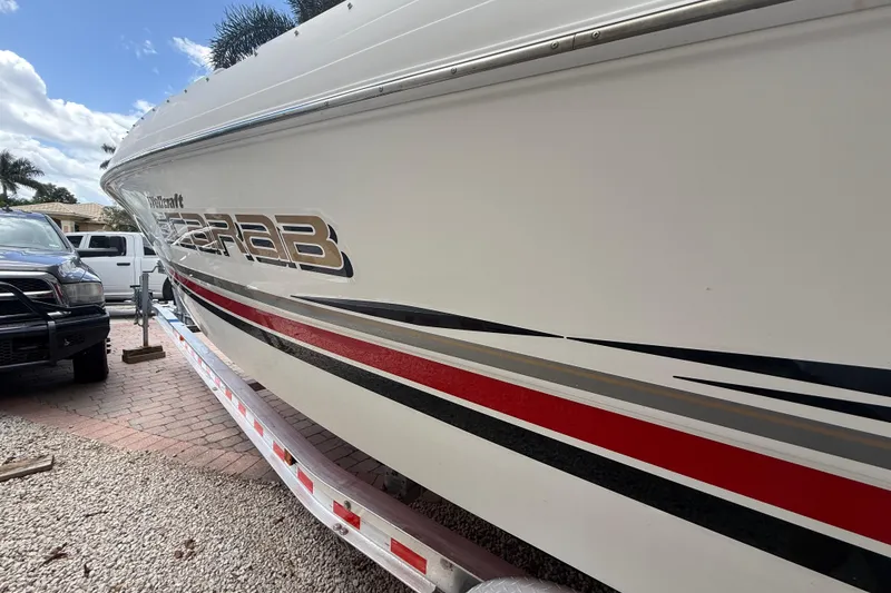 Slide: The Image of 2001 Wellcraft 29 Scarab Sport Open boat with sleek design and bold graphics. - 6