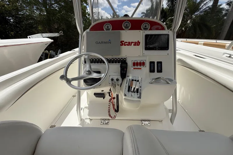 Slide: The Image of Center console of 2001 Wellcraft 29 Scarab Sport Open boat with Garmin navigation. - 64