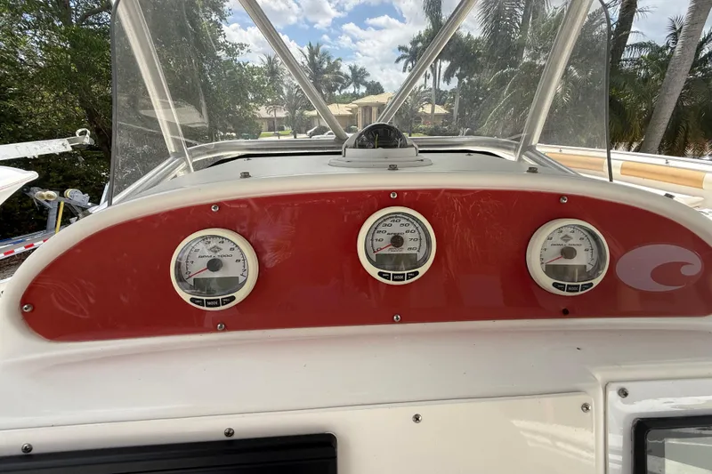Slide: The Image of Dashboard of a 2001 Wellcraft 29 Scarab Sport Open boat with gauges and windshield. - 69