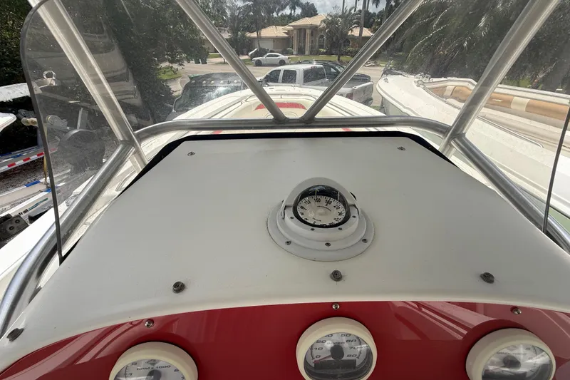 Slide: The Image of 2001 Wellcraft 29 Scarab Sport Open boat dashboard with compass and gauges. - 70