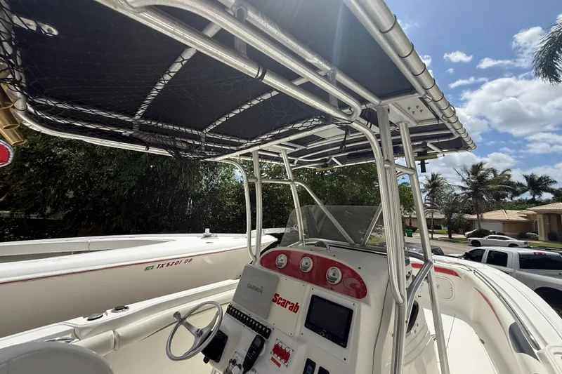 Slide: The Image of 2001 Wellcraft 29 Scarab Sport Open boat cockpit with steering wheel and canopy. - 73