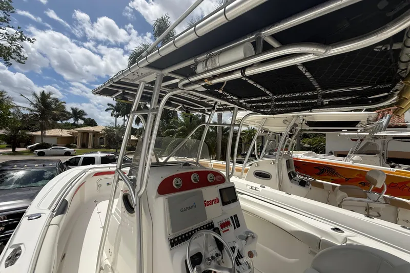 Slide: The Image of 2001 Wellcraft 29 Scarab Sport Open boat with T-top and Garmin navigation system. - 76