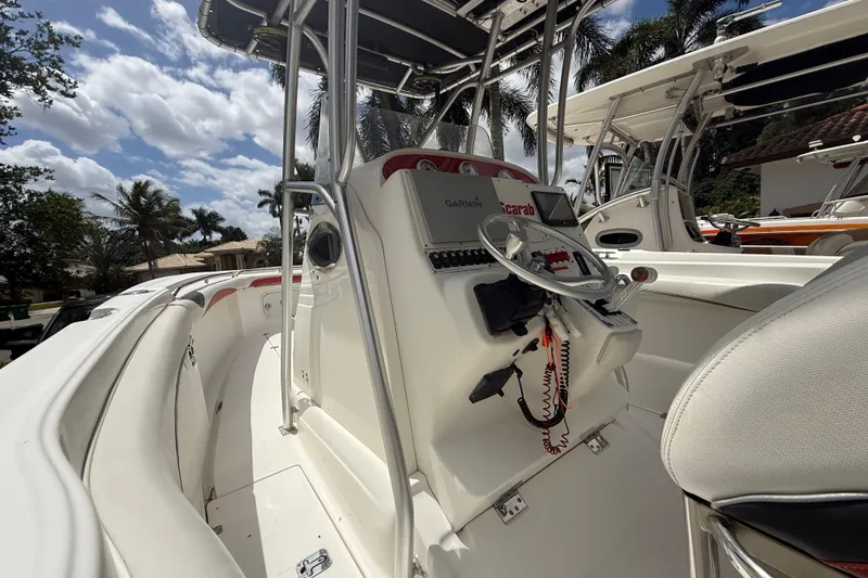 Slide: The Image of 2001 Wellcraft 29 Scarab Sport Open boat interior with steering console and seating. - 78