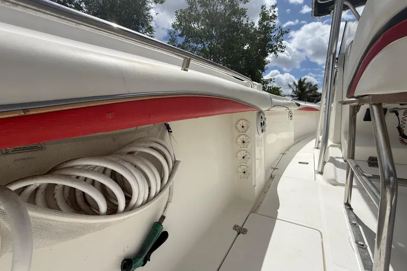 Slide: The Image of 2001 Wellcraft 29 Scarab Sport Open boat interior with coiled hose and seating. - 81