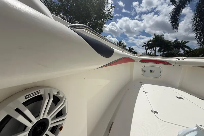 Slide: The Image of 2001 Wellcraft 29 Scarab Sport Open boat interior with speaker, under a partly cloudy sky. - 84