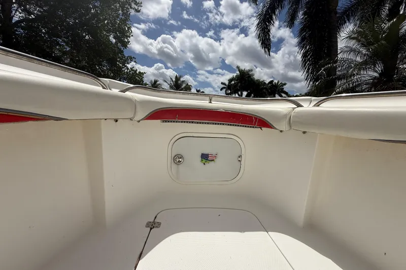 Slide: The Image of 2001 Wellcraft 29 Scarab Sport Open boat interior with palm trees and cloudy sky. - 87